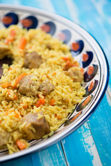 Close-up of uzbek traditional pilaf in a plate with ornaments