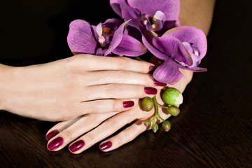 Woman applying nail varnish to finger nails