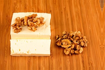 White goat cheese with noble rot on wooden table