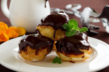 profiteroles with cream and chocolate sauce.