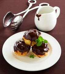 profiteroles with cream and chocolate sauce.