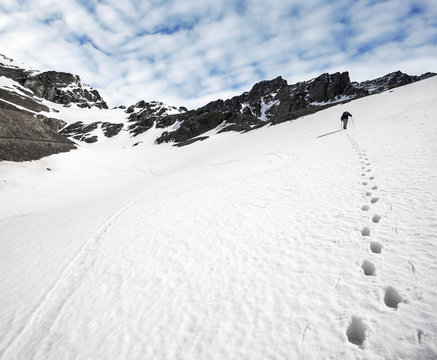 Trekker and footprints in the snow, Ushuaia, Argentina.