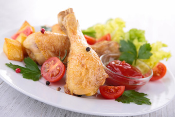 chicken drumsticks and vegetables