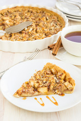 Slice of delicious fresh baked  apple pie on a wooden surface