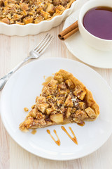 Slice of delicious fresh baked  apple pie on a wooden surface