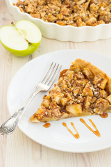 Slice of delicious fresh baked  apple pie on a wooden surface