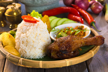 indonesian fried chicken rice on traditional background