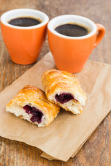Breakfast with buns jam and two cups of coffee