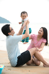 chinese asian family playing on the beach