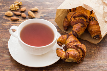 Cup of tea with croissant