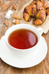 Cup of tea with croissant and cinnamon