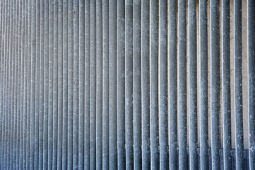 Striped metal vertical rough grated wall
