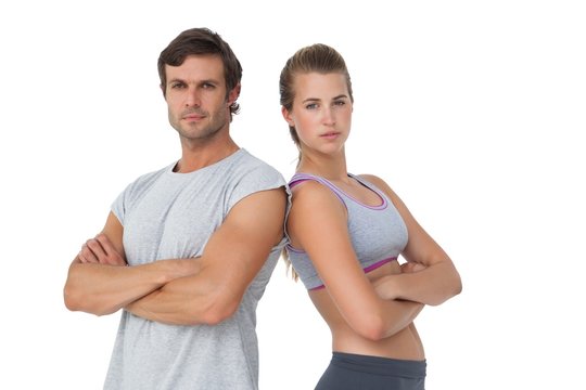 Portrait of a sporty couple with arms crossed