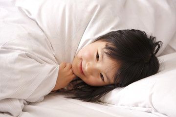 girl under bedclothes