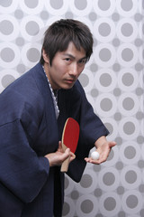 man in yukata playing table tennis