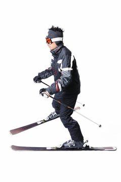One male skier skiing with full equipment on a white background