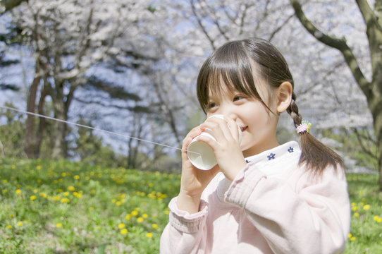girl talking on string telephone