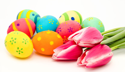 Colorful easter eggs and flowers isolated on a white