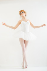 Beautiful girl dressed as a ballerina. Fashion makeup. Stylish h