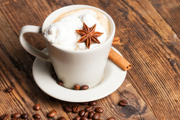 Delicious cup of coffee in a rustic background.