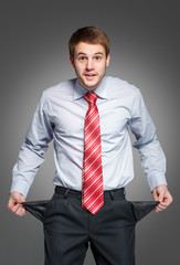 businessman showing his empty pocket, turning his pocket inside