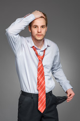 businessman showing his empty pocket, turning his pocket inside