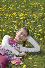 Girl in the flowering meadow laughing
