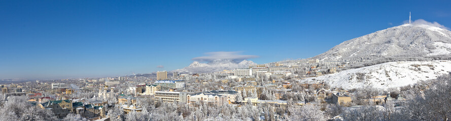City panorama against mountains.