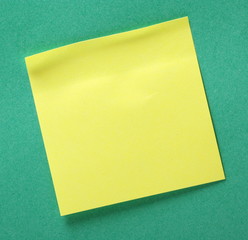 Yellow Sticky Note with Copy Space on Green background