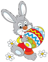 Little rabbit carries a big painted Easter egg