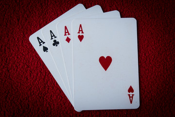 Four aces  on red background