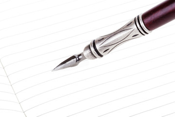 Writing in a text book with luxury retro ink pen isolated
