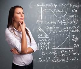 Beautiful school girl thinking about complex mathematical signs