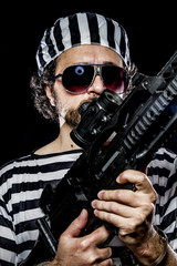 Opposition, Prison riot concept. Man holding a machine gun, pris