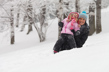 Portrait of a joyful mother and her daughter smiling in winter - 61909291
