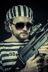Suppresion, Prison riot concept. Man holding a machine gun, pris