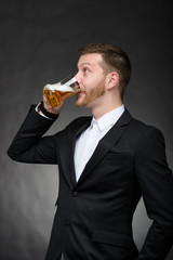 Fototapeta premium young man with beard drinking beer