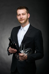 handsome romanitc man holding bottle and glasses of wine