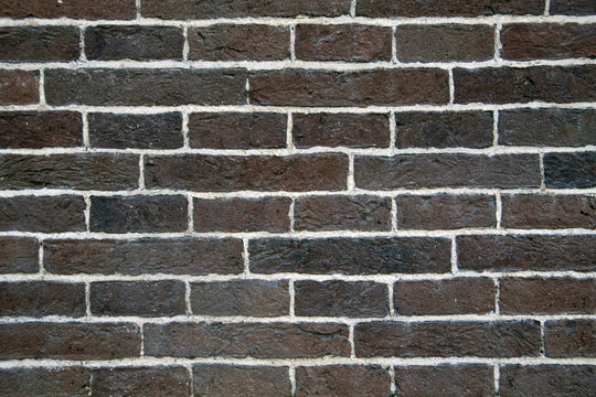 Old brown wall with white joints -  Image for background.