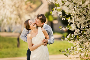 Fototapeta premium Portrait of young loving couple in flowering park