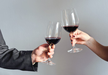 Hands holding wine glasses