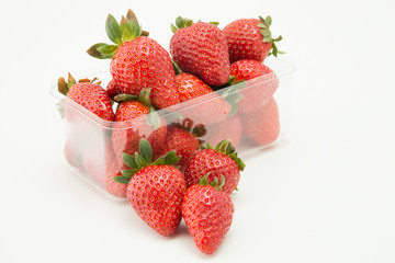 Strawberries in transparent plastic recipient ready to be sold