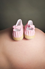 Baby booties and a pregnancy bump