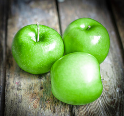 Fresh farm raised apples on rustic wooden background