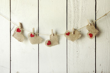 Happy Valentine Burlap Hearts Hanging on a Wood Wall