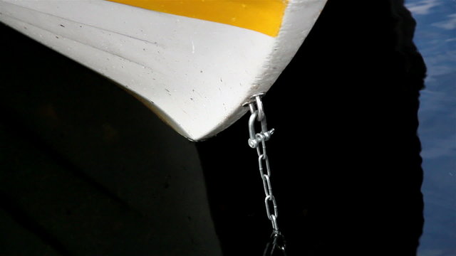 Anchor attached to chain on row boat