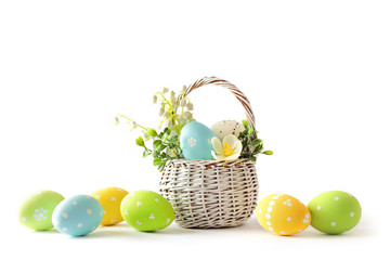 easter eggs in basket isolated on white background
