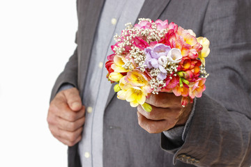 Man holding bouquet of colorful freesia flowers