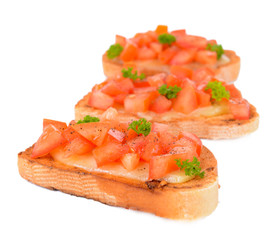 Delicious bruschetta with tomatoes isolated on white