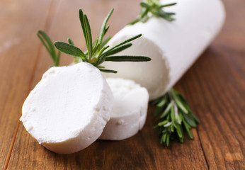 Tasty bushe cheese with rosemary, on wooden table © Africa Studio